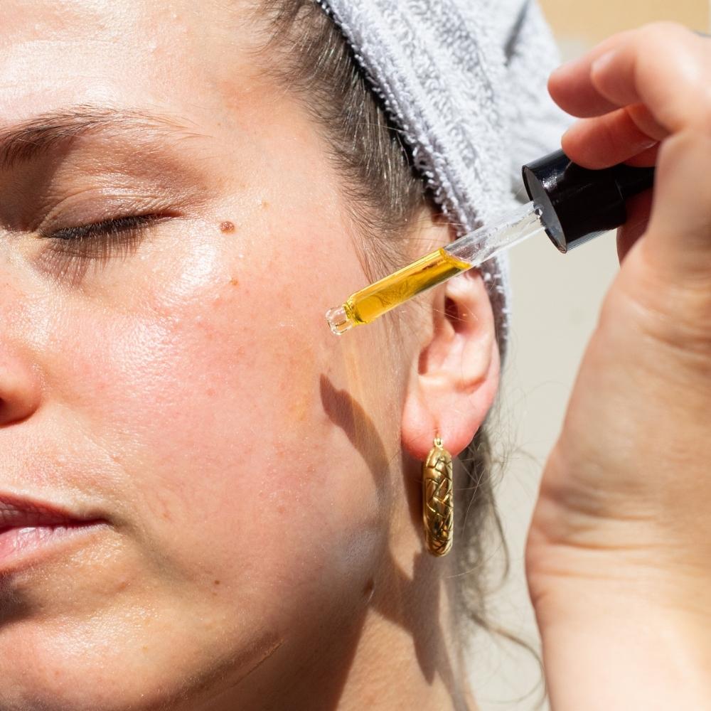 Woman applying face oil