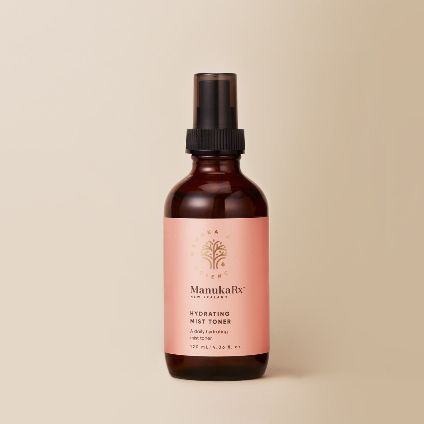 Bottle of ManukaRx Hydrating Mist Toner with cream background