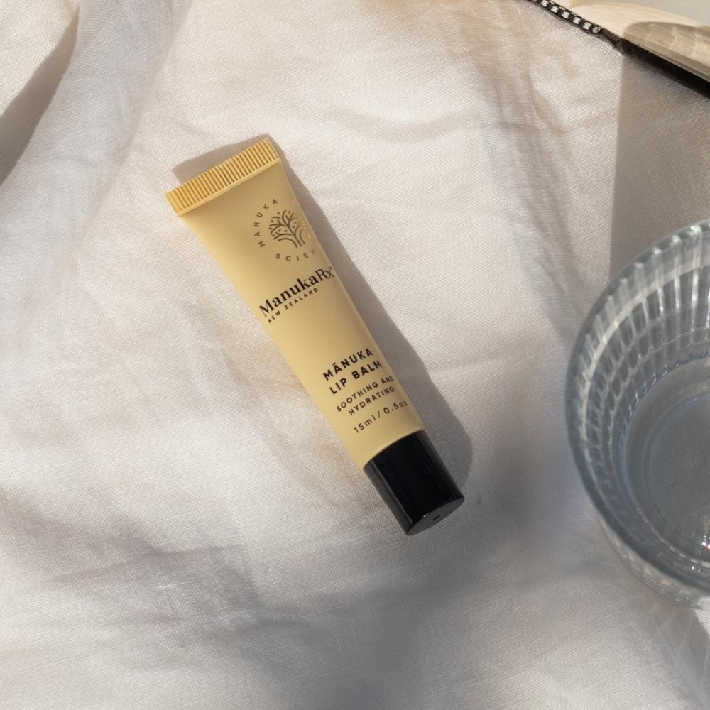 ManukaRx Mānuka Lip Balm on white fabric background