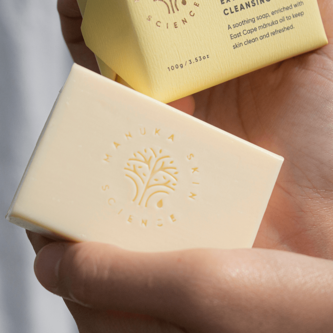 Hands holding a bar of ManukaRx Extra Gentle Cleansing Soap