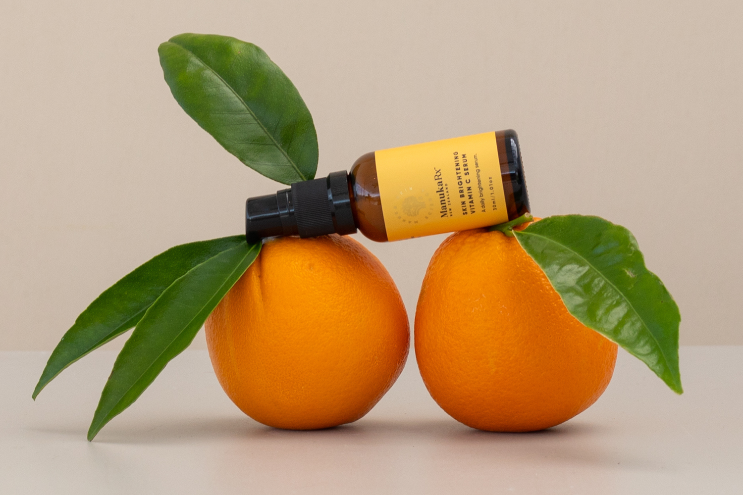 ManukaRx Skin Brightening Vitamin C Serum on oranges