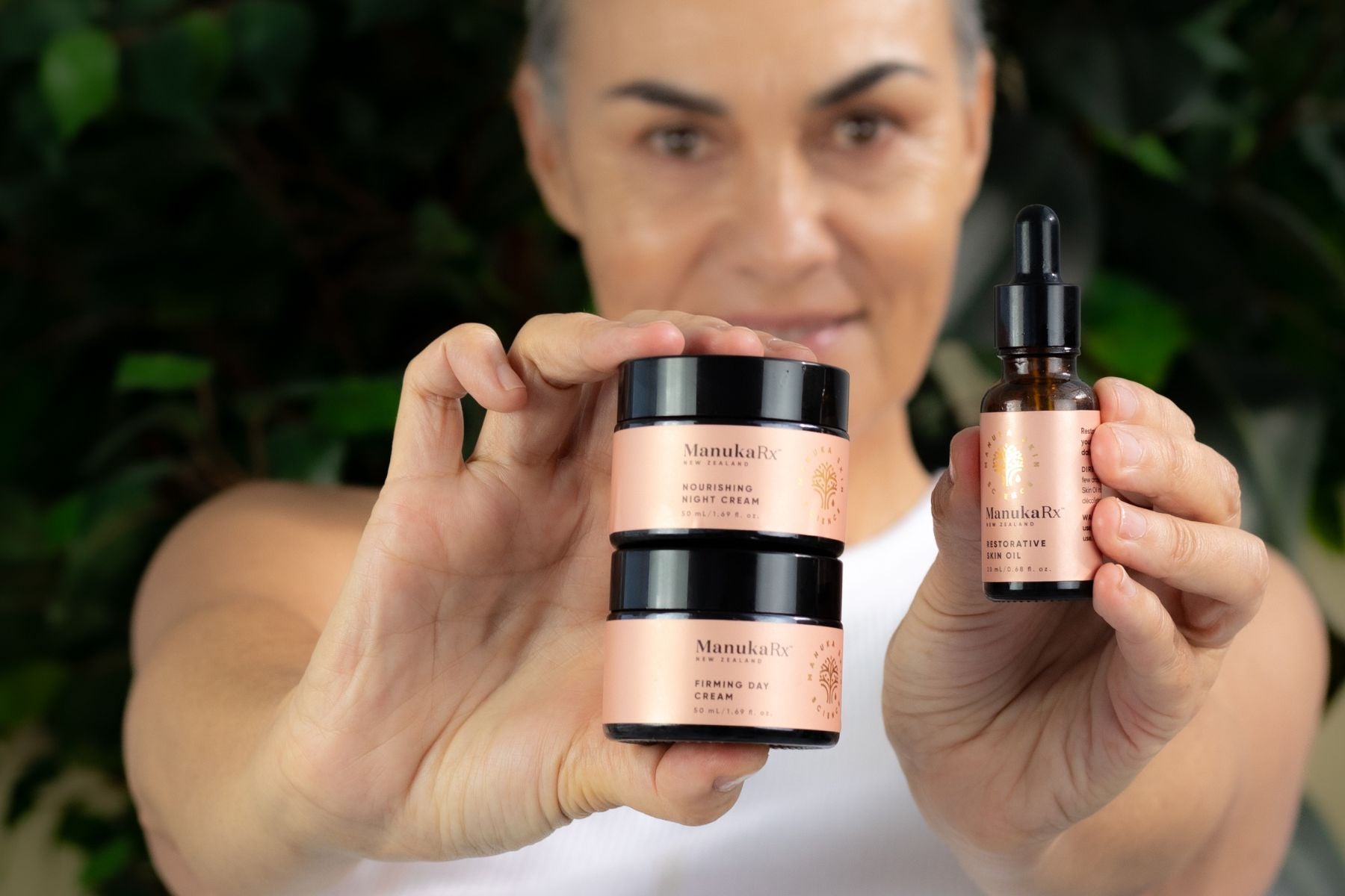 Synergistic Skincare: What You Need To Know image showing a mature woman using ManukaRx Pro-Aging skin oil with Manuka and rosehip oil for anti-aging benefits.