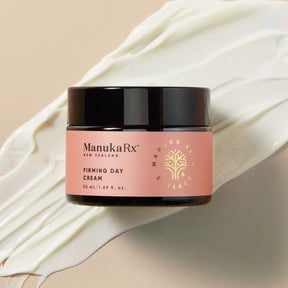 A pot of ManukaRx Firming Day Cream is displayed on a beige background